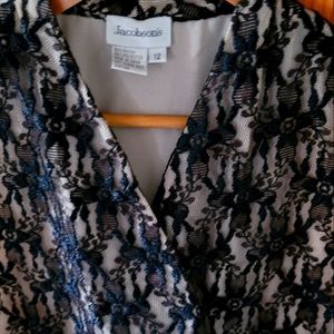Jacobson black laced short sleeve blouse with beige background